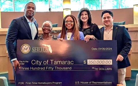 Congresswoman Cherfilus-McCormick presenting a check