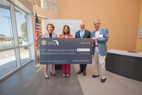 Congresswoman Cherfilus-McCormick holds oversized check to announce Community Project Funding.
